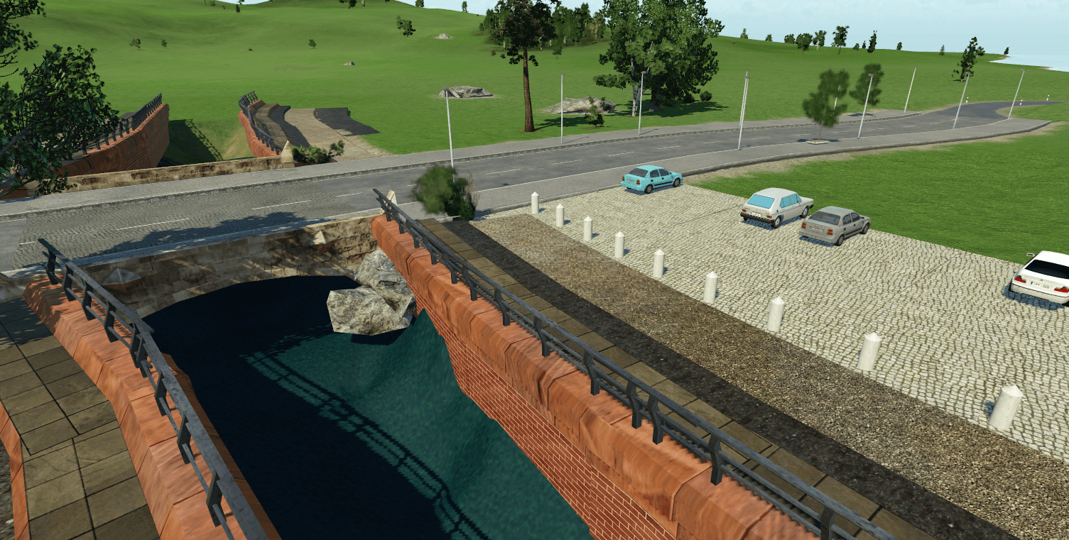 Flusslauf mit Straßenbrücke und Parkplatz