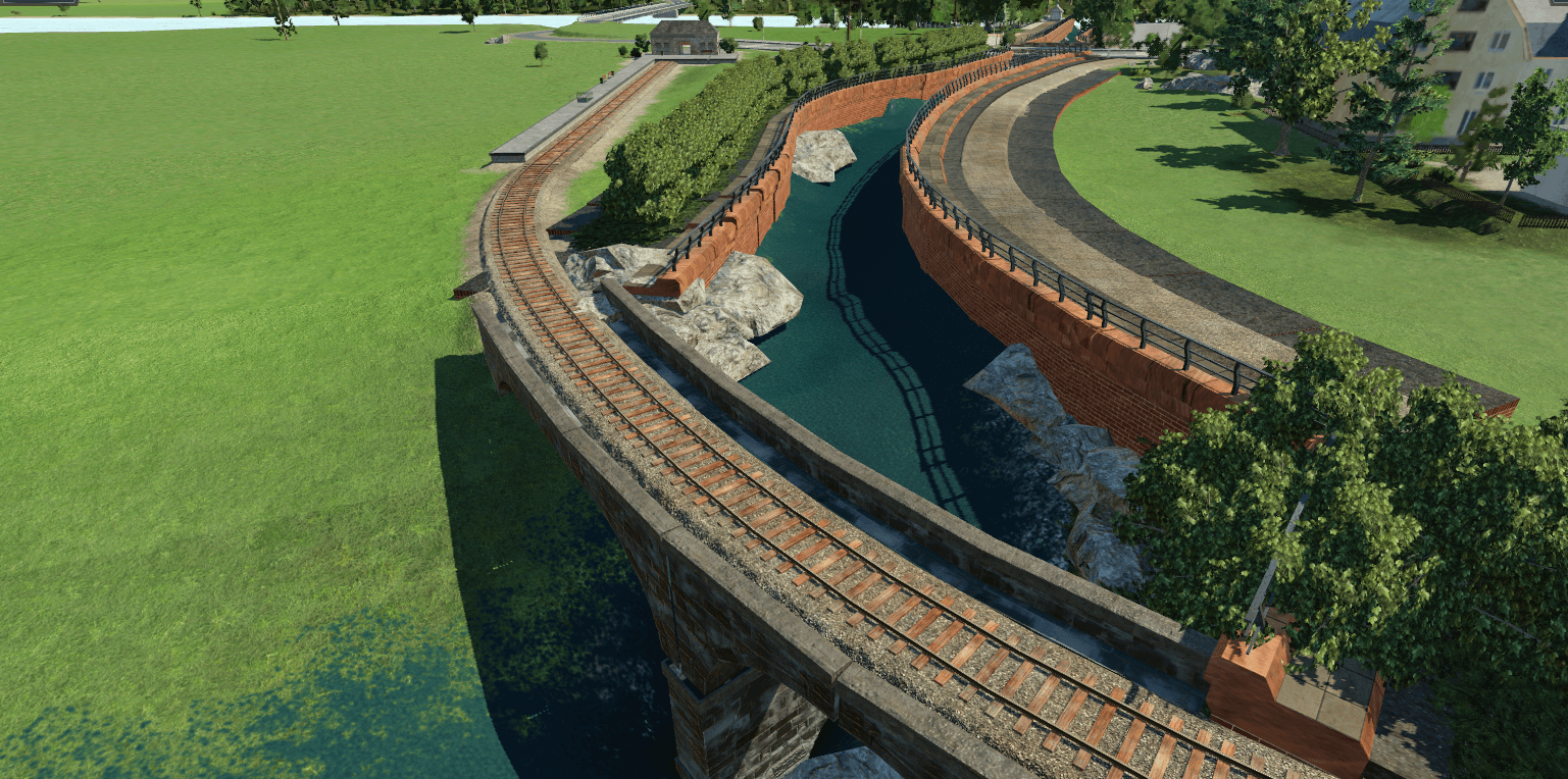Flusslauf mit Mauer als Begrenzung, Eisenbahnbrücke und Radweg