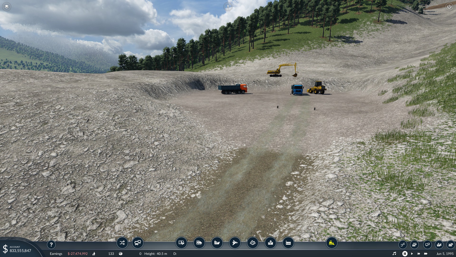 Tipper trucks waiting to be loaded with material near the top of the slide.