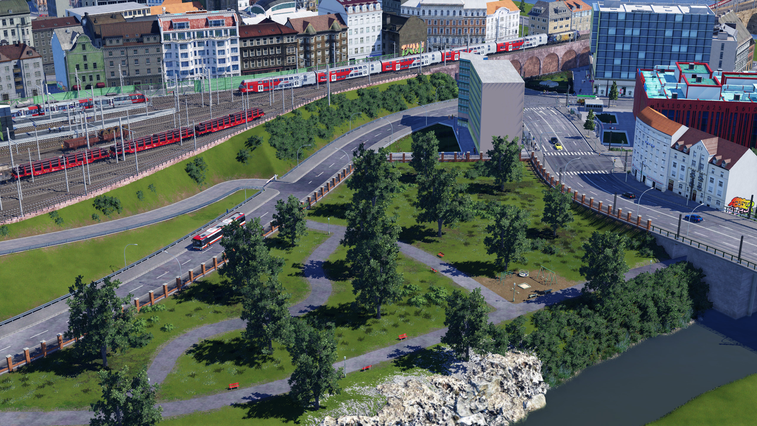 Park mit Bahn im Hintergrund