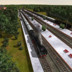 Mehrer Nahverkehrszüge und ein Fernverkehrszug bei der Durchfahrt.