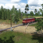 Eine unbekannte BR 242 an einem einsamen Bahnübergang im Wald