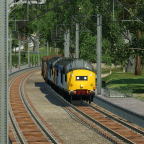 2 GB Railfreight 37s haul a long coal train through Hadfield to Fiddler's Ferry power station near Liverpool.