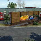 neue Map (Prignitz) - BR119 fährt entlang der Graffiti-Wand und Feuerwehr