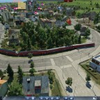 Gleiche Straße, zwei Bahnübergänge - mit Zug